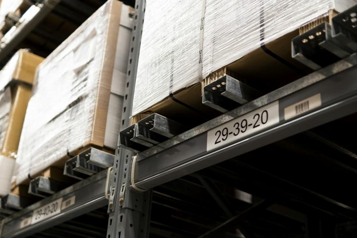 a close up of a metal shelf with boxes on it