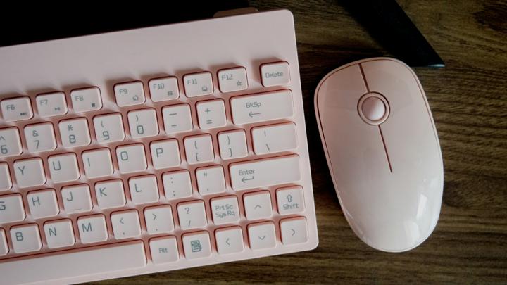 a computer keyboard and mouse on a desk