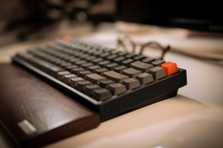 a computer keyboard sitting on top of a desk