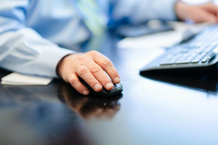 a man is typing on a computer keyboard