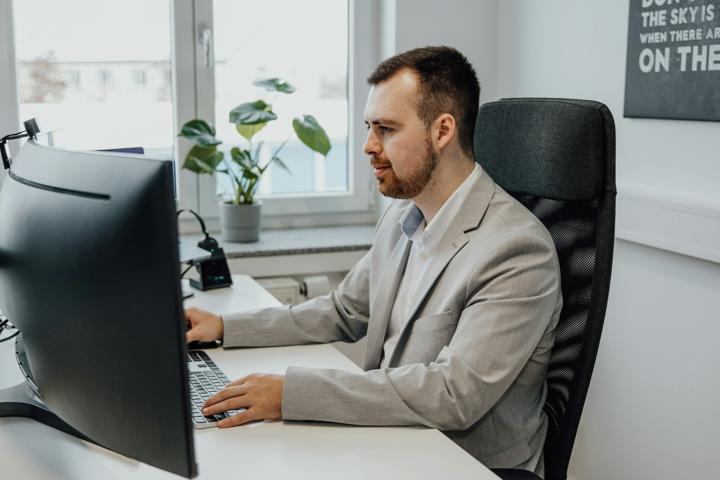 a person typing on a laptop on a table