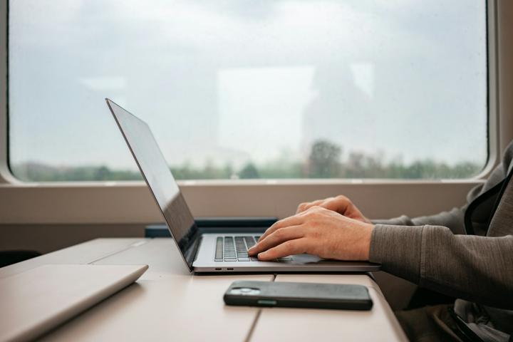 grayscale photo of person using MacBook