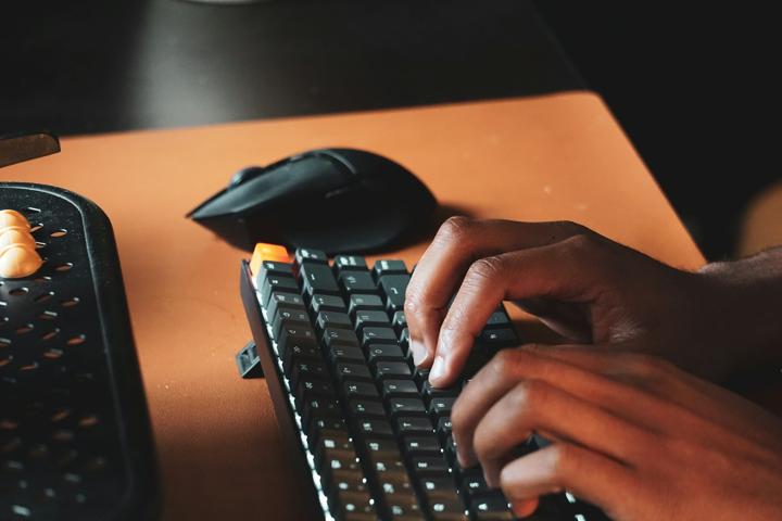 a person is typing on a computer keyboard