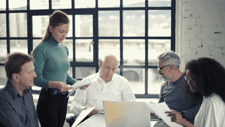 four business people meeting around office table