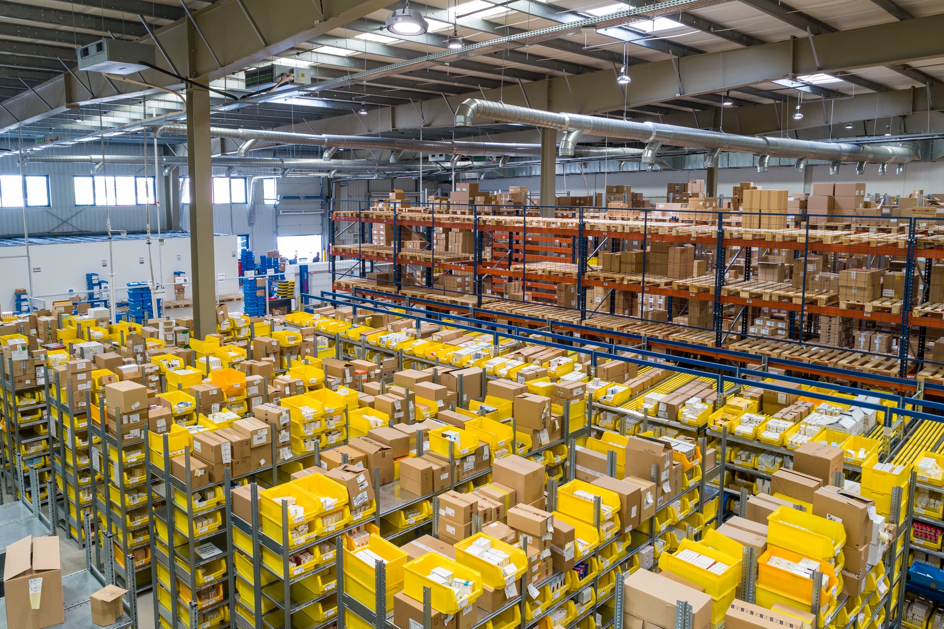 NetSuite WMS Warehouse Management System Module yellow and white plastic box lot