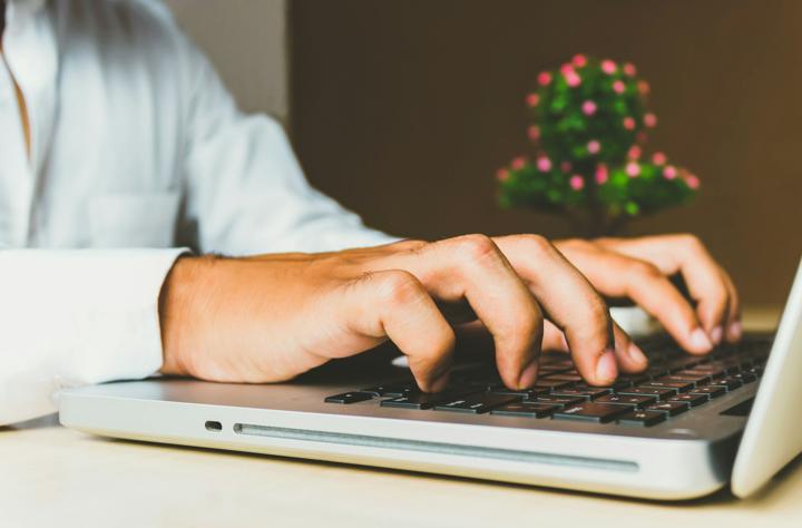 person using grey laptop computer