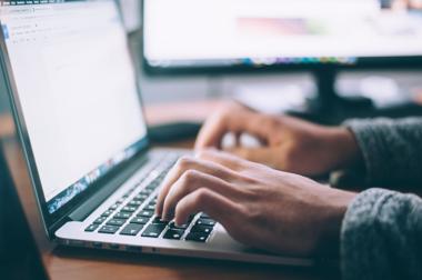 man on computer using netsuite project management module