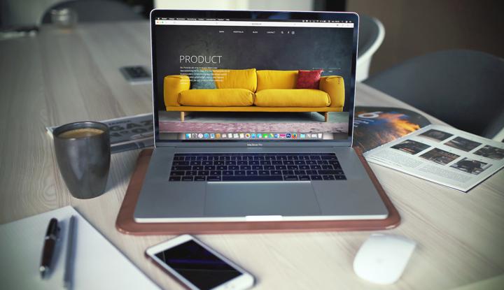 a person sitting at a table with a laptop