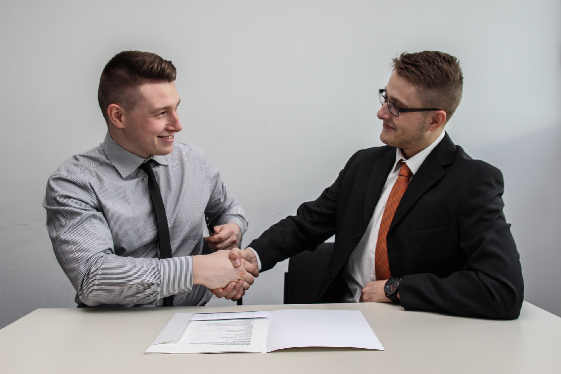 two men shaking hands customer relationship managementnet