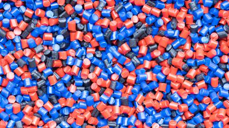 mixture of red and blue polymer pellets