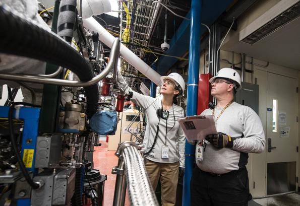 industrial workers inspecting a plastic extrusion line