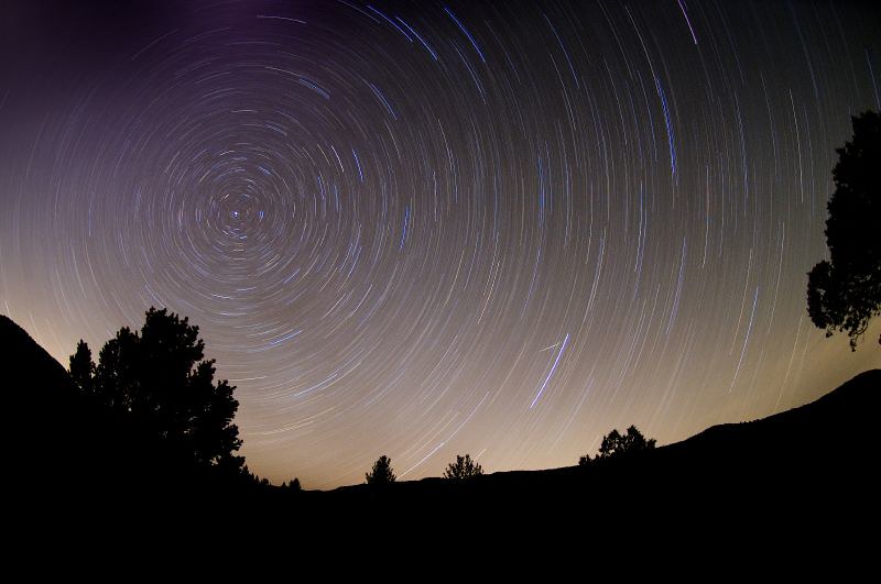 a star trail over a body of water
