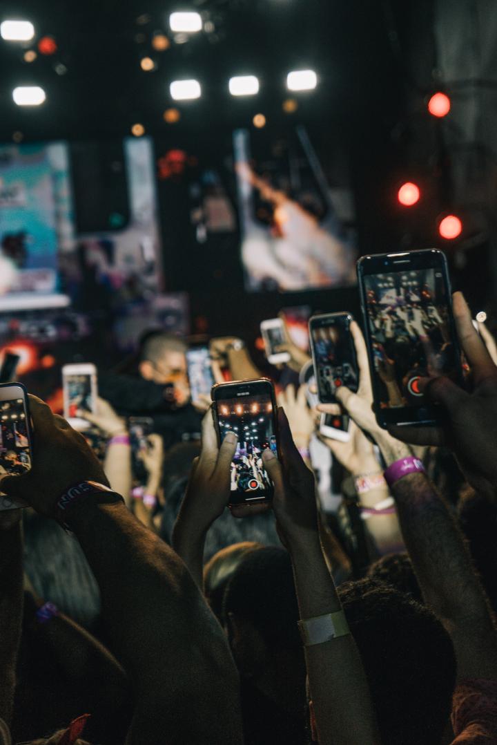 shallow focus photography of crowd taking video