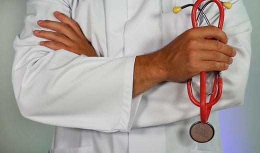 doctor holding red stethoscope