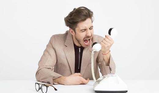 man holding telephone screaming