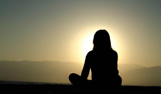 woman sitting on sand