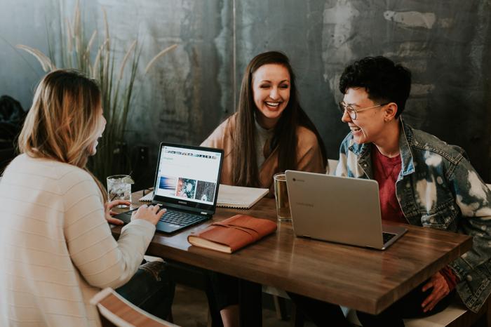 3 people at a table excited about all the leads they are generating