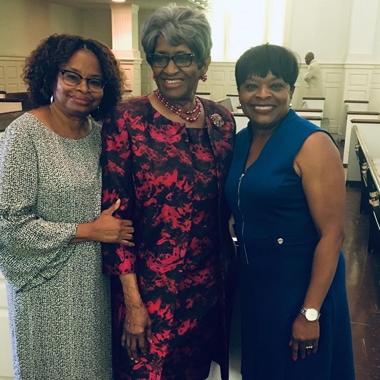 Caregiver smiling with her sister and mother