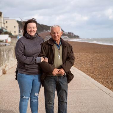 Caregiver with her dad outside near the beach