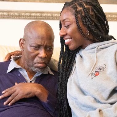 Caregiver smiling with her father