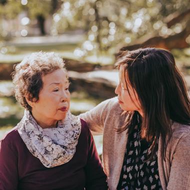 Caregiver hugging her mother outside