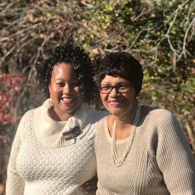 Caregiver smiling with her mother in nature