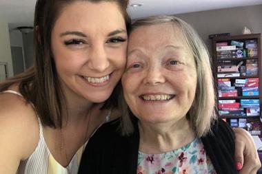 Caregiver hugging her mother and smiling