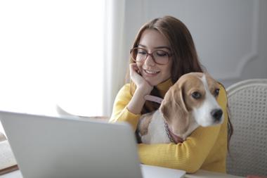 woman and dog using computer